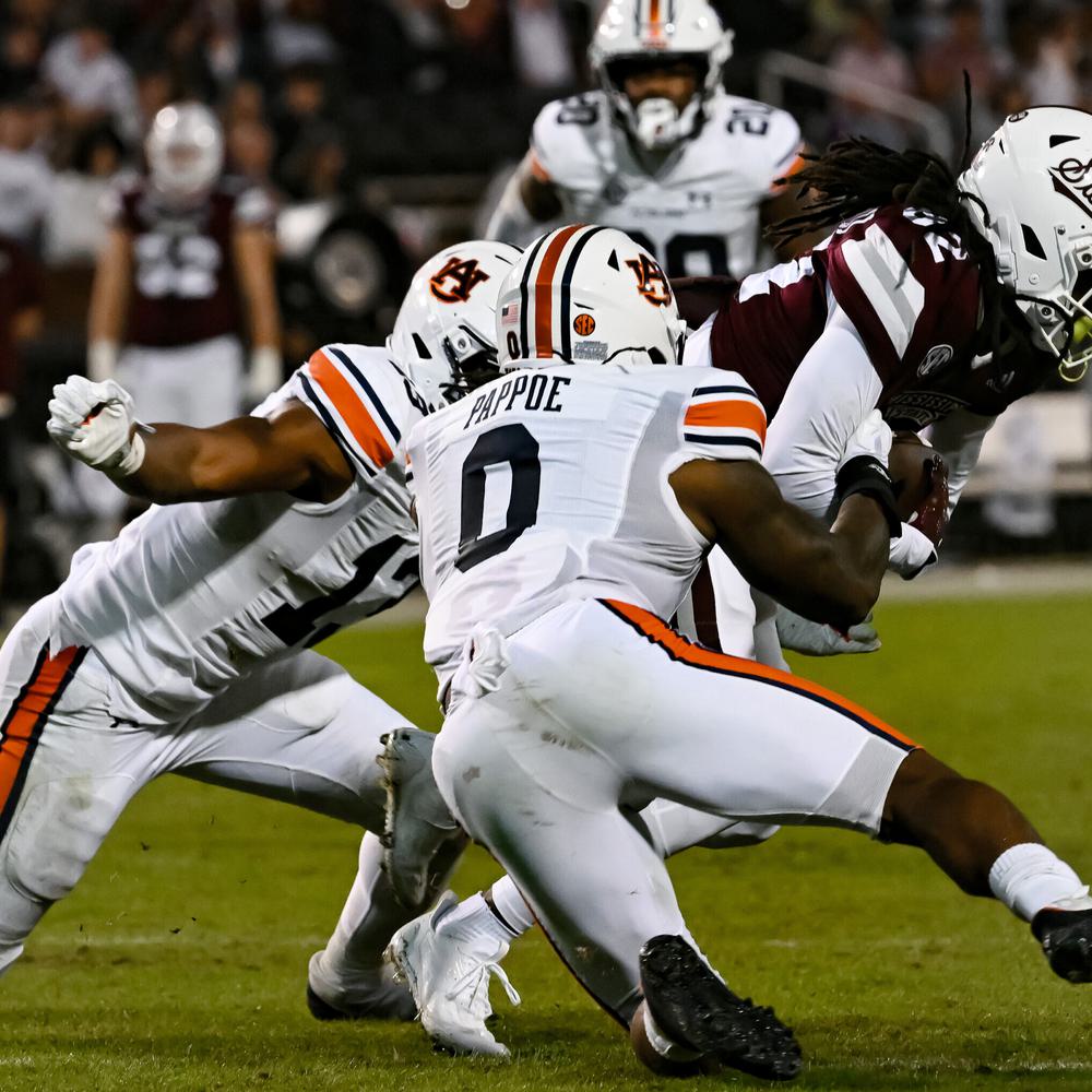 Starkville, MS, USA; Owen Pappoe (0) and Cam Riley (13) tackle MSU offense between Auburn and Mississippi State at Davis Wade Stadium . Alabama News