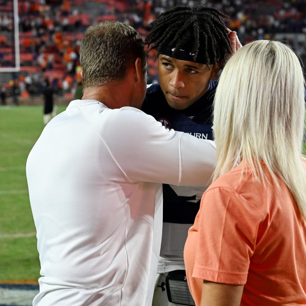 Coach Bryan Harsin hugs Robby Ashford and wife Kes Harsin after the game on Saturday, Oct. 1, 2022 in Auburn. Alabama News