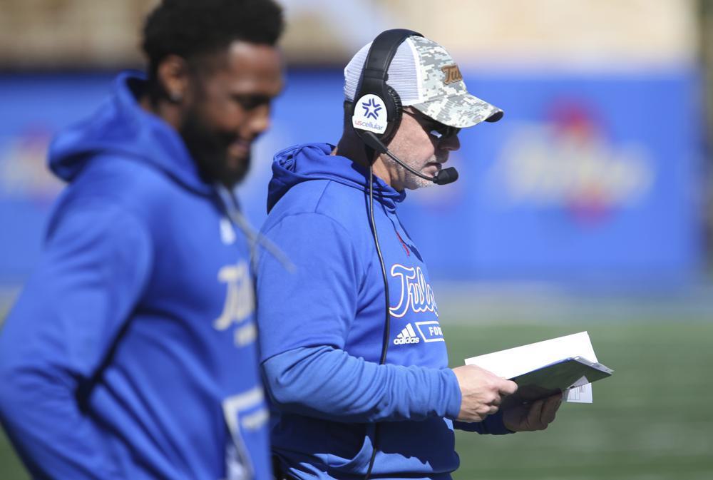 Tulsa head Philip Montgomery check his notes during their NCAA college football game against Tulane in Tulsa, Okla. on Saturday, Nov. 5, 2022. (AP Photo/Dave Crenshaw)