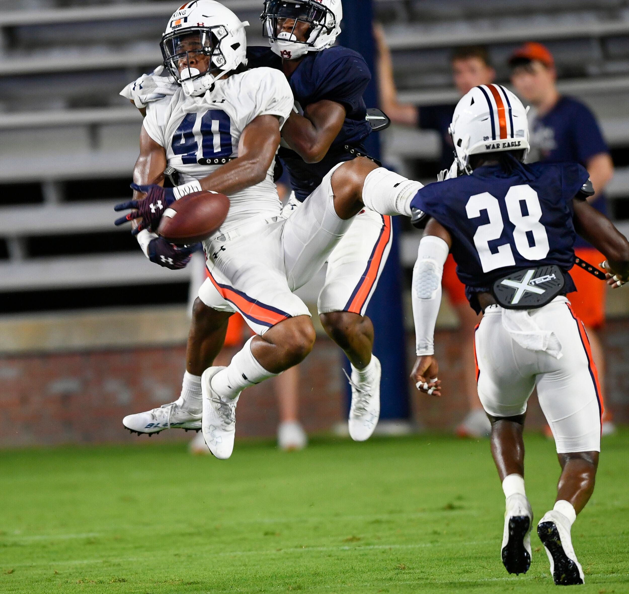 2 Landen King (40) is unable to hang-on defended by Trey Elston  (22). Auburn football scrimmage 1 on Saturday,  Aug. 14, 2021 in Auburn, Ala. Todd Van Emst/AU Athletics