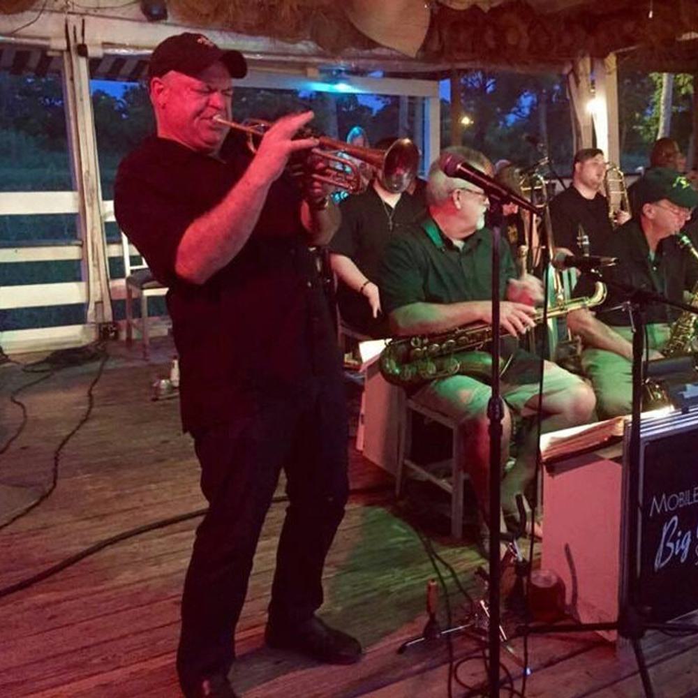 Attorney Chip Herrington, conductor of Mobile Big Band, blows trumpet solo at Bluegill on the Causeway.  Second from left is Federal Judge William Steele, a saxophonist. Alabama News