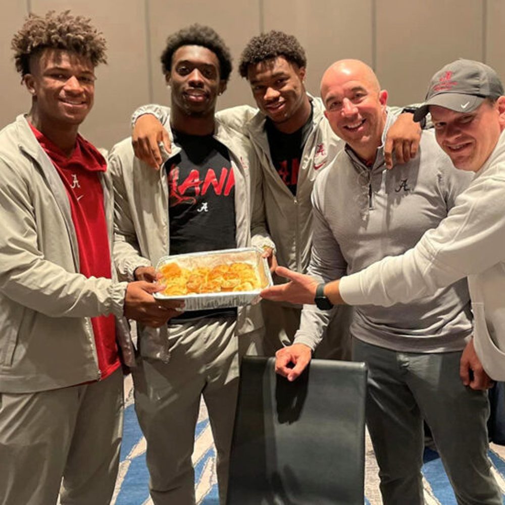 Bama players and staff serving Waysider biscuits in Pasadena. Photo: Waysider Alabama News