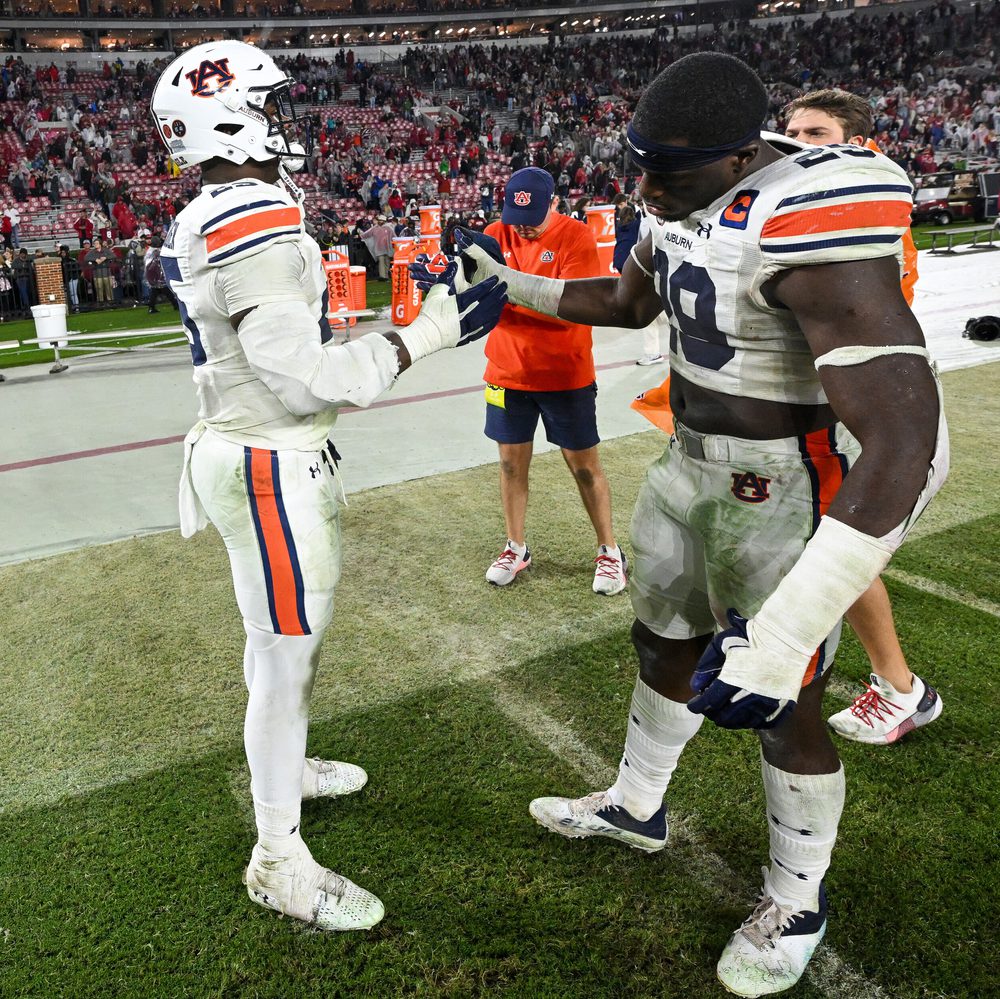 Colby Wooden (25) and Derick Hall (29) share a moment after the game. Auburn vs Alabama on Saturday, Nov. 26, 2022 in Tuscaloosa, Ala. Todd Van Emst/AU Athletics Alabama News
