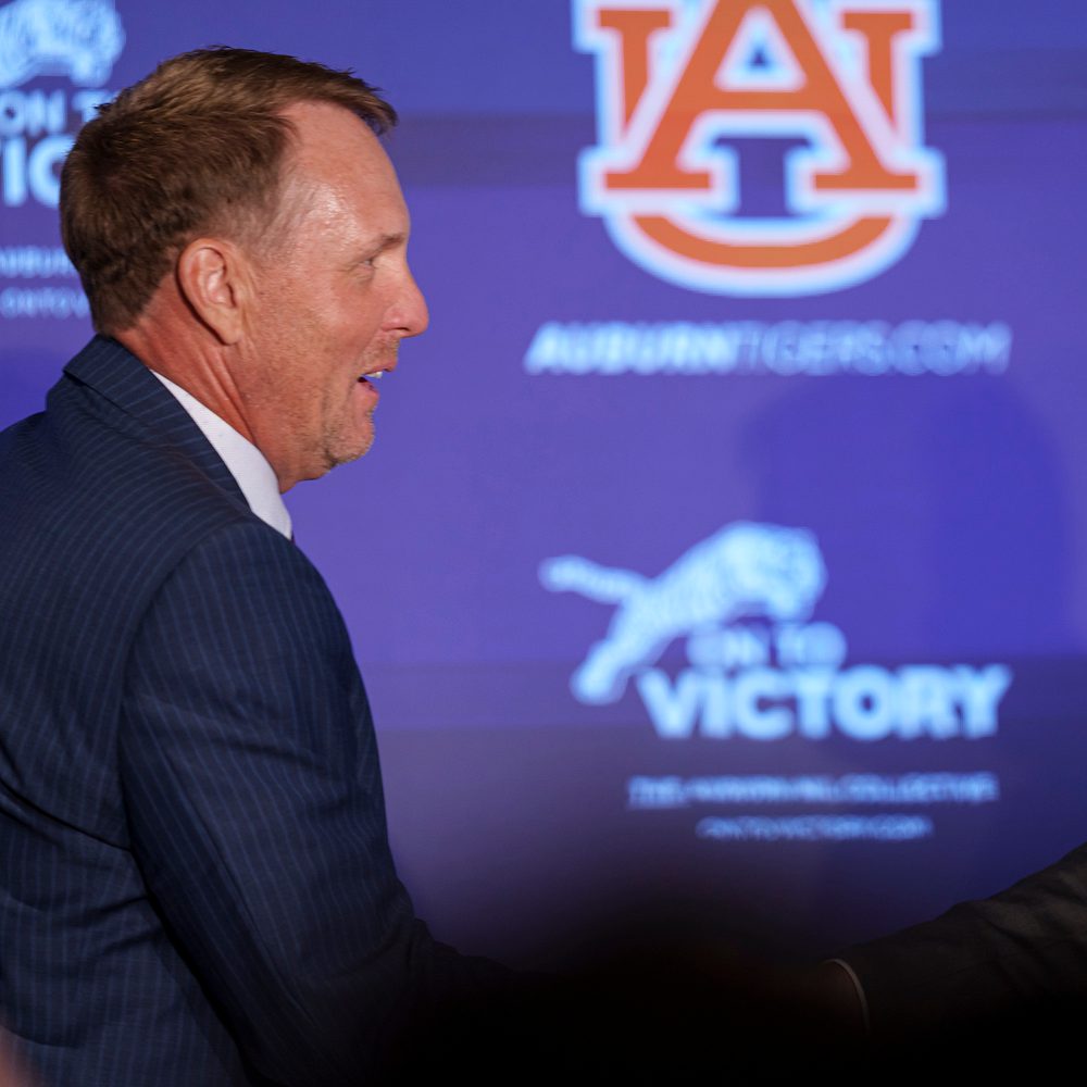 22 AUBURN, AL - November 29, 2022 - Auburn Head Football Coach Hugh Freeze and Athletics Director John Cohen embrace during Hugh Freeze’s introductory press conference at the Woltosz Football Performance Center in Auburn, AL. Photo By Austin Perryman Alabama News