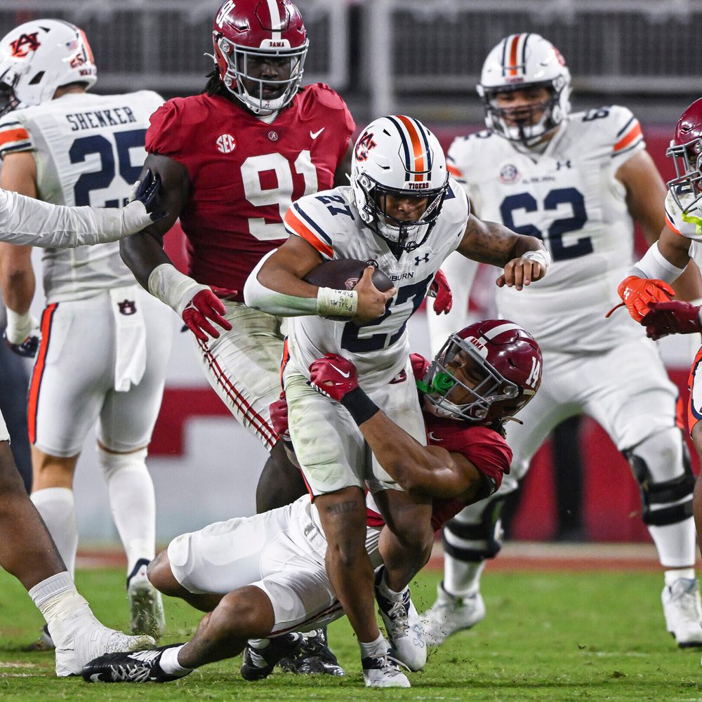 Nov 26, 2022; Tuscaloosa, Al, USA; Jarquez Hunter (27) tries to break the tackle during the game between Auburn and Alabama at Bryant-Denny Stadium. Alabama News
