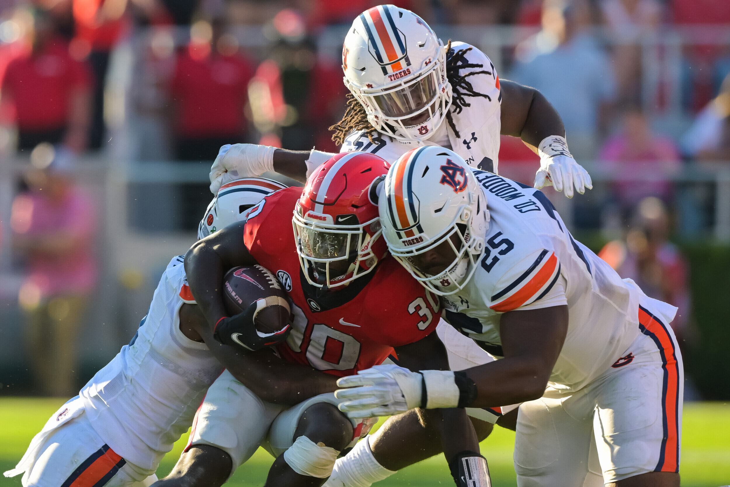 Athens, GA, USA; Colby Wooden (25) tackles Georgia offense during the game between Auburn and Georgia at Sanford Stadium.