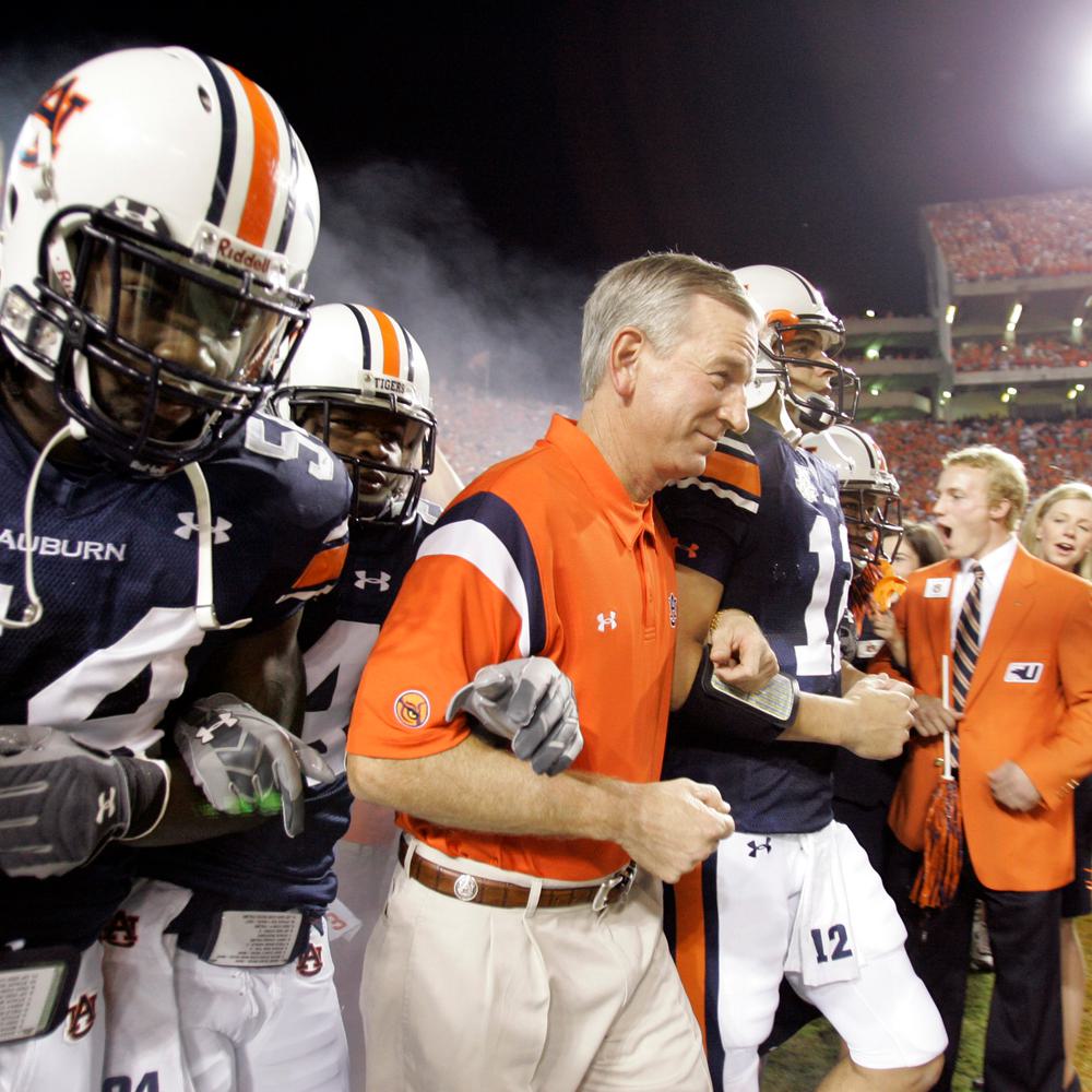 Auburn coach Tommy Tuberville, center, leads players Quentin Groves, left, and Brandon Cox, right, onto the field before the start of a football game against South Florida, Saturday Sept. 8, 2007, in Auburn, Ala. Alabama News