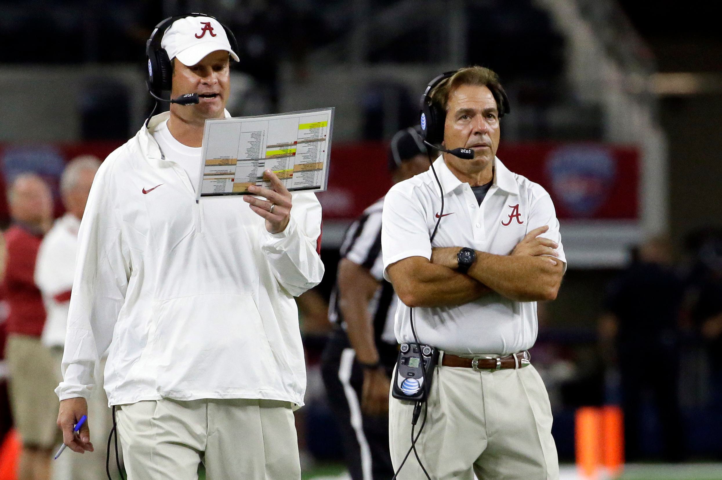 Alabama head coach Nick Saban, right, looks on as offensive coordinator Lane Kiffin calls a play on the sidelines
