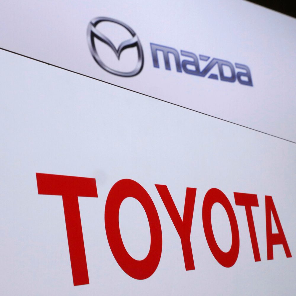 FILE- In this Aug. 4, 2017, file photo, logos of Toyota Motor Corp., bottom, and Mazda Motor Corp., top, are placed prior to a news conference in Tokyo. Japanese automakers Toyota and Mazda have picked Alabama as the site of a new $1.6 billion joint-ventu Alabama News