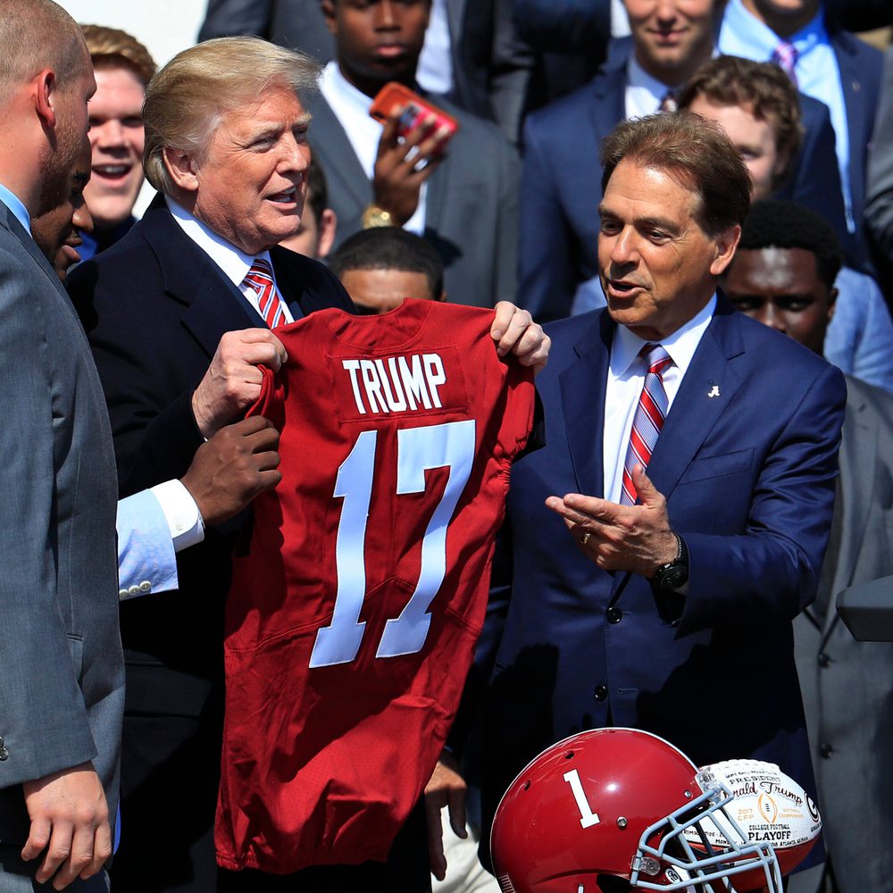 President Donald Trump holds up a team jersey presented to him by the 2017 NCAA football national champions, the Alabama Crimson Tide, during a ceremony honoring the champions on the White House's South Lawn, in Washington, Tuesday, April 10, 2018. On th Alabama News