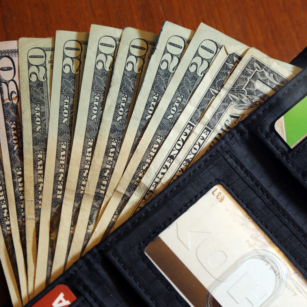 FILE - Cash is fanned out from a wallet in North Andover, Mass., June 15, 2018. Parenting comes with many responsibilities, and one is raising financially independent kids. Generally, it’s best to leave the money in your retirement accounts safely tucked Alabama News