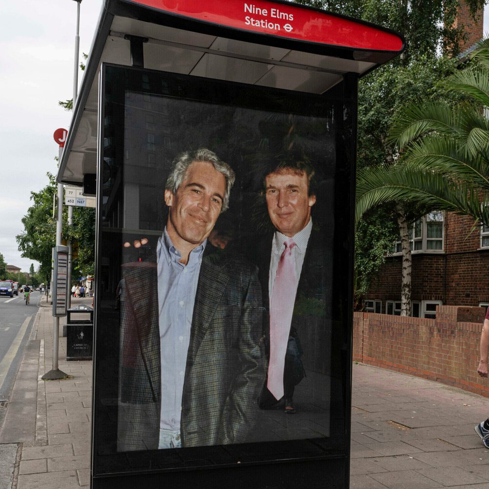 Commuters walk past a bus stop near Nine Elms Station as activists put up a poster showing President Donald Trump and Jeffrey Epstein near the US Embassy in London, Thursday, July 17, 2025.(AP Photo/Thomas Krych) Alabama News