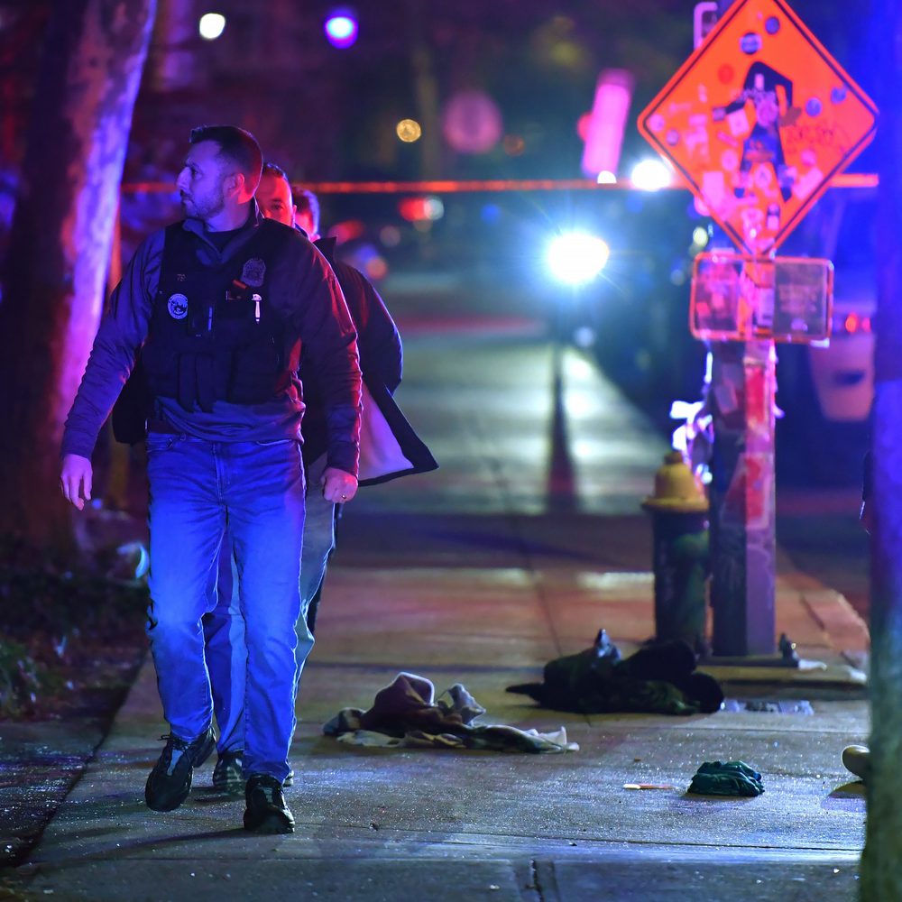 A law enforcement official walks past articles of clothing on a sidewalk near an entrance to Brown University, Saturday, Dec. 13, 2025, in Providence, R.I., during the investigation of a shooting. (AP Photo/Steven Senne) Alabama News
