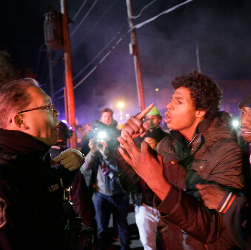 Protesters confront a police officer on Nov. 25, 2014 in Ferguson, Mo. Alabama News