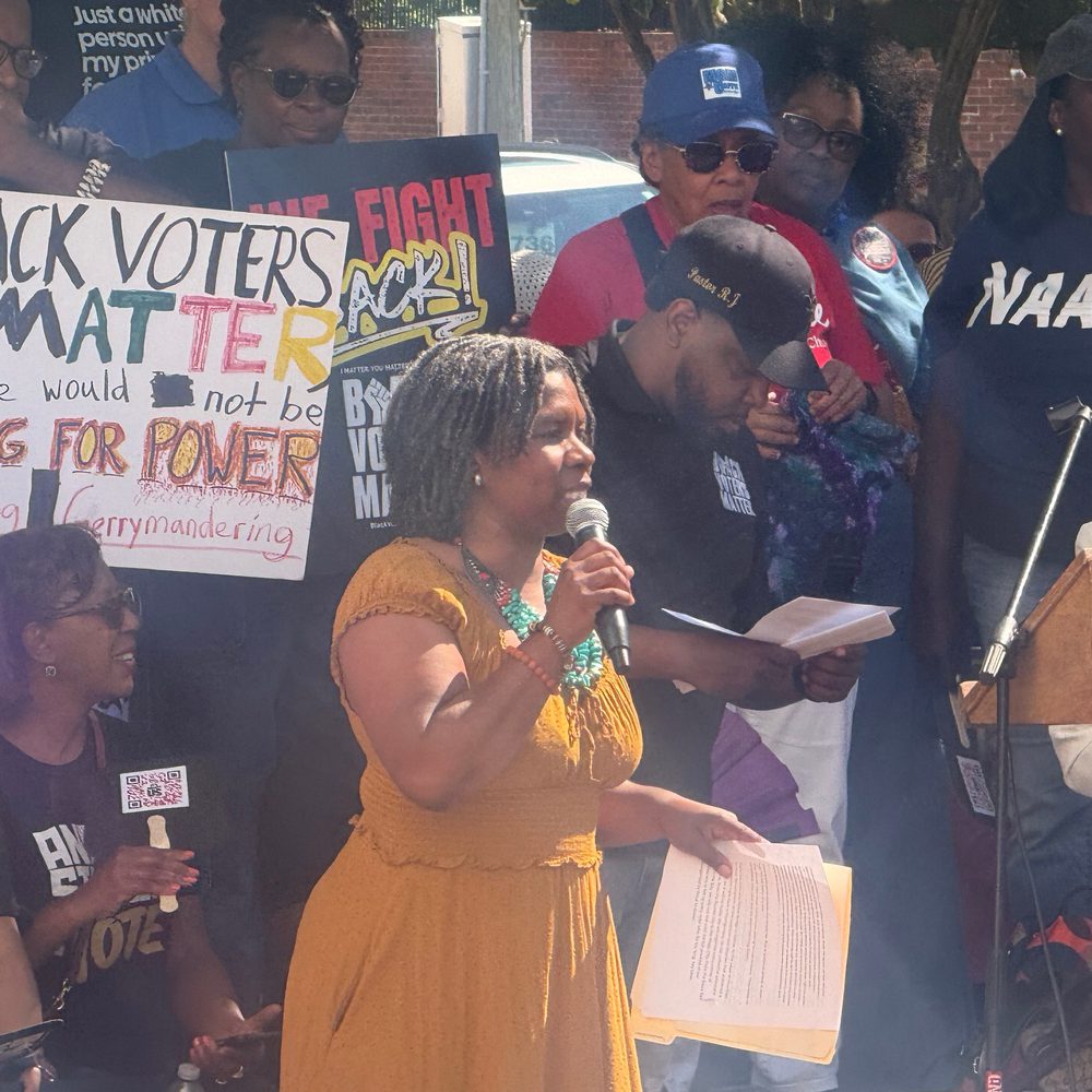 Tafeni English-Relf, the director of the SPLC’s Alabama State Office speaks against state redistricting efforts at a scheduled protest at the Alabama State House. Photo: Craig Monger. Alabama News