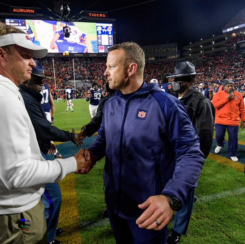 Auburn, AL, USA; Coach Bryan Harsin reacts with Lane Kiffin after the game between Auburn and Ole Miss at Jordan-Hare Stadium. Alabama News