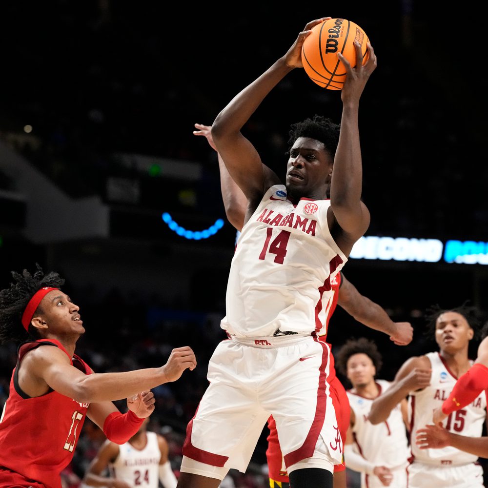 Alabama center Charles Bediako (14) pulls down a rebound while guarded by Maryland guard Ian Martinez, left, during the second half of a second-round college basketball game in the men's NCAA Tournament in Birmingham Alabama News