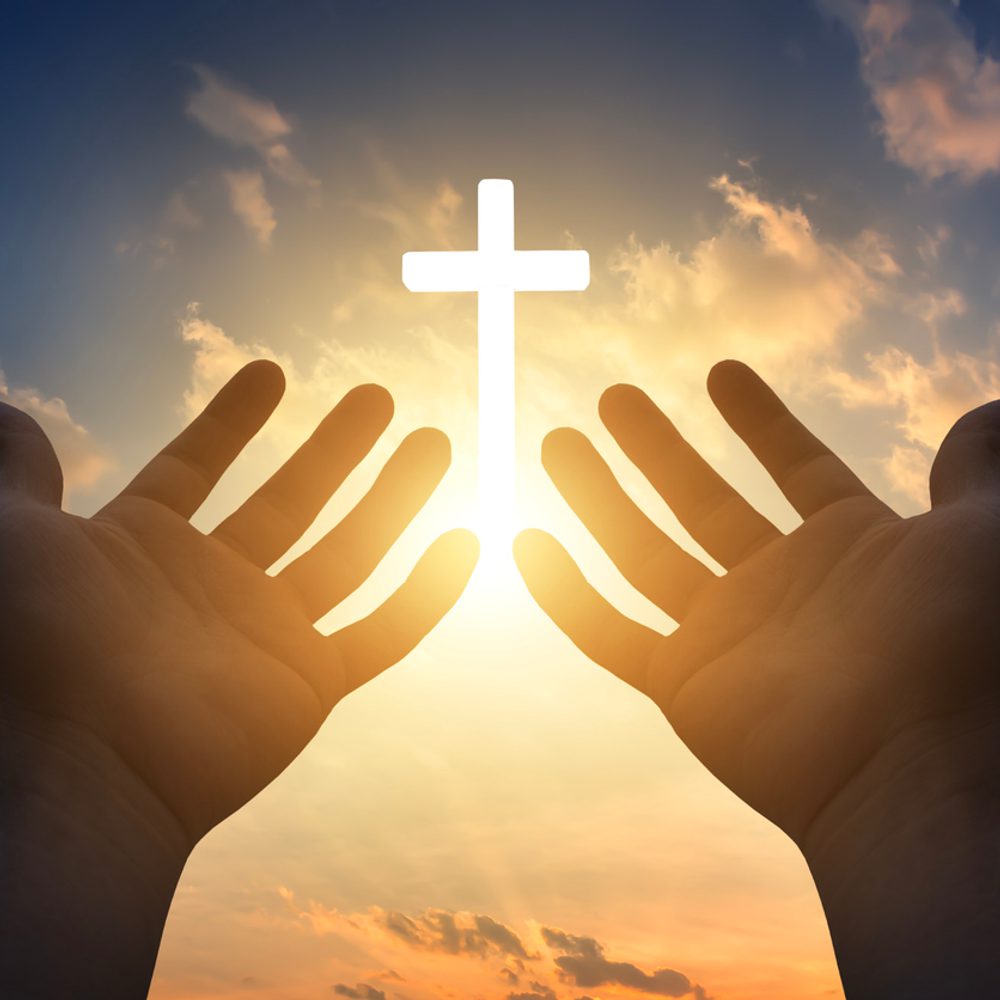 Prayer concept, Human hands open palm up to worship god Jesus Christ on cross background stock photo Alabama News