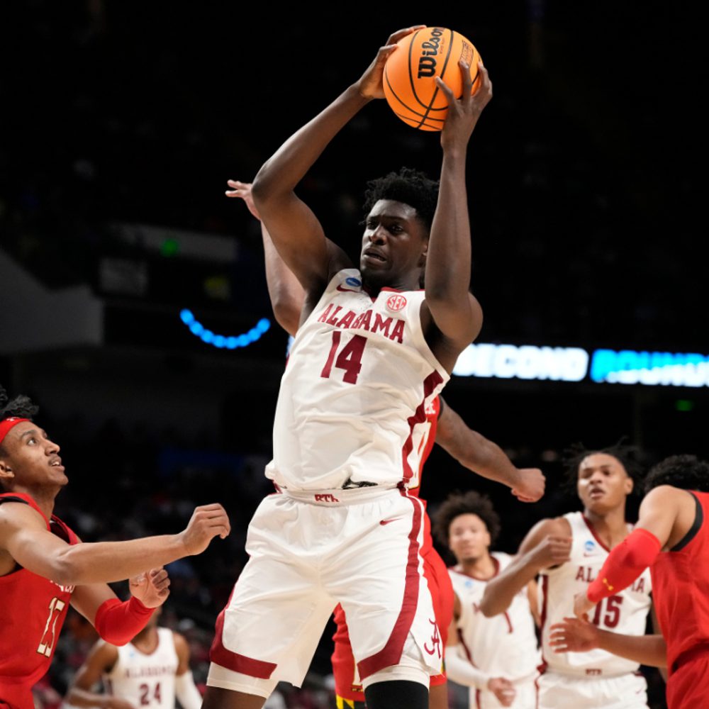 Alabama center Charles Bediako (14) pulls down a rebound while guarded by Maryland guard Ian Martinez, left, during the second half of a second-round college basketball game in the men's NCAA Tournament in Birmingham, Ala., Saturday, March 18, 2023. (AP P Alabama News