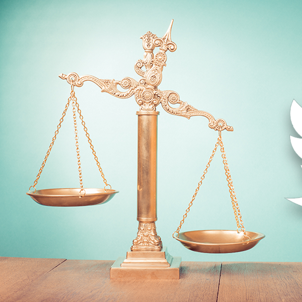 Bronze law scales on table. Symbol of justice. Twitter Alabama News