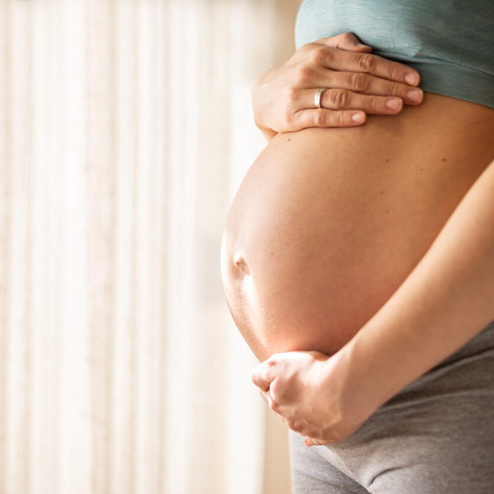 Pregnant woman embracing her belly stock photo Alabama News