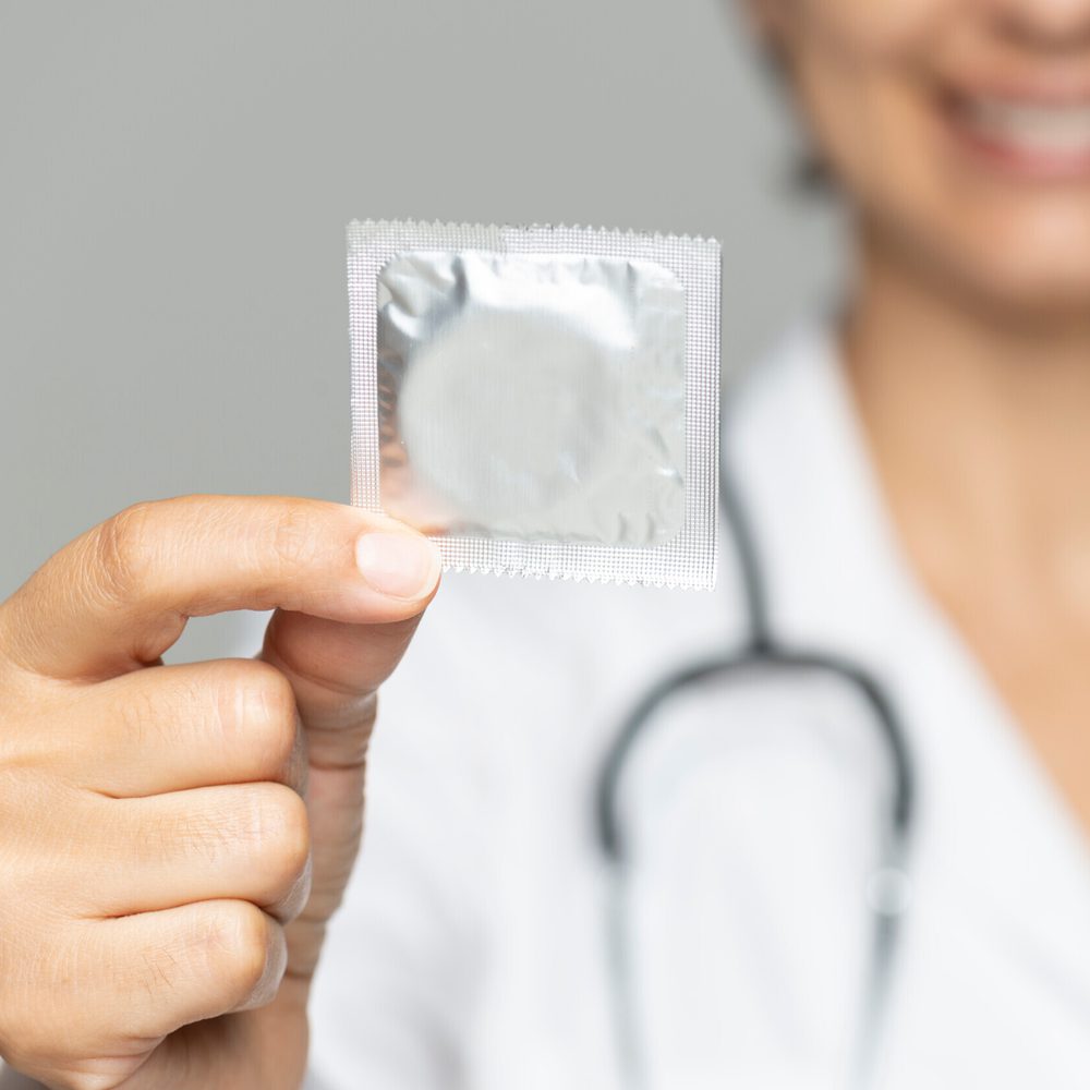 Doctor holding and showing condom. Alabama News