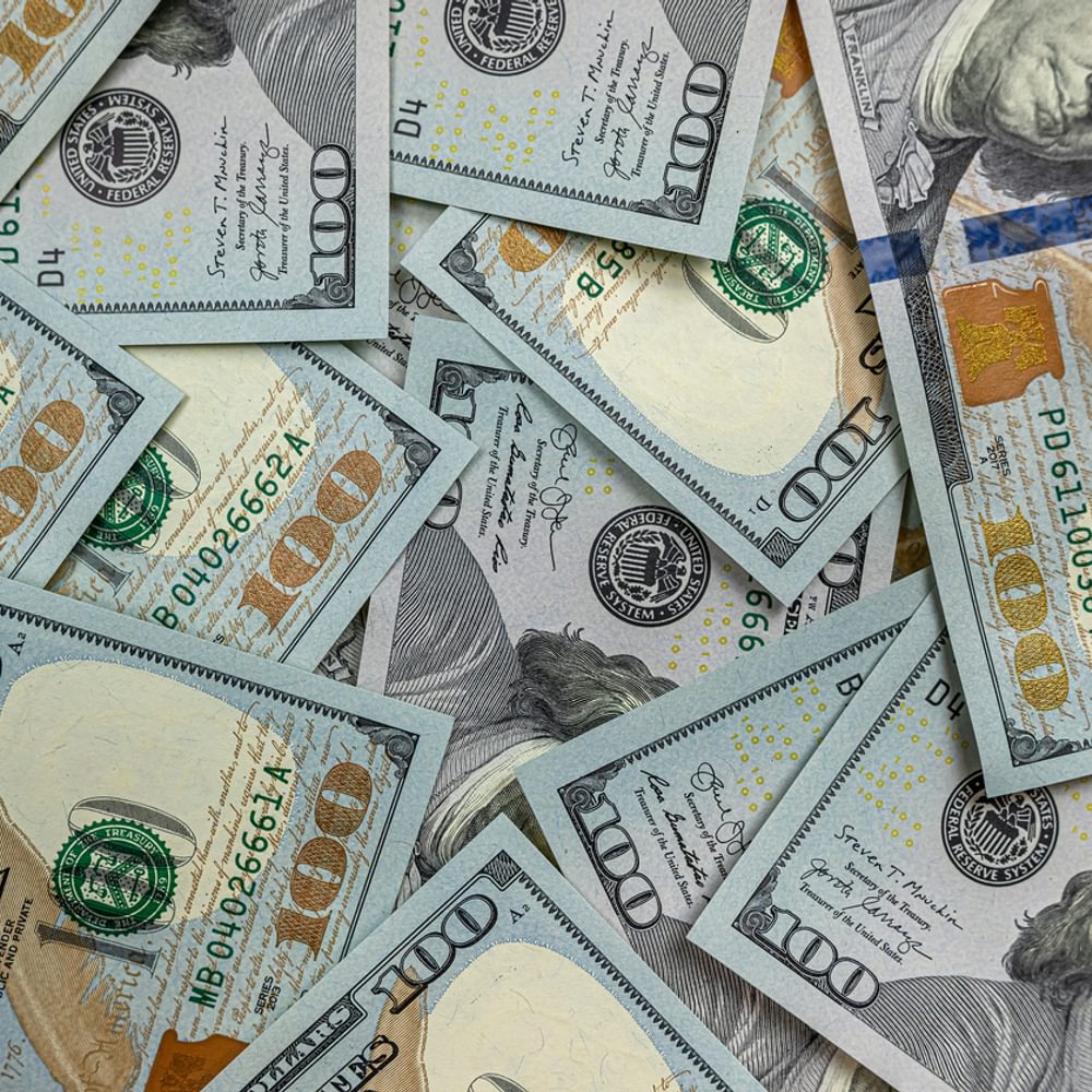 100 new US dollar bills on black background stock photo Alabama News