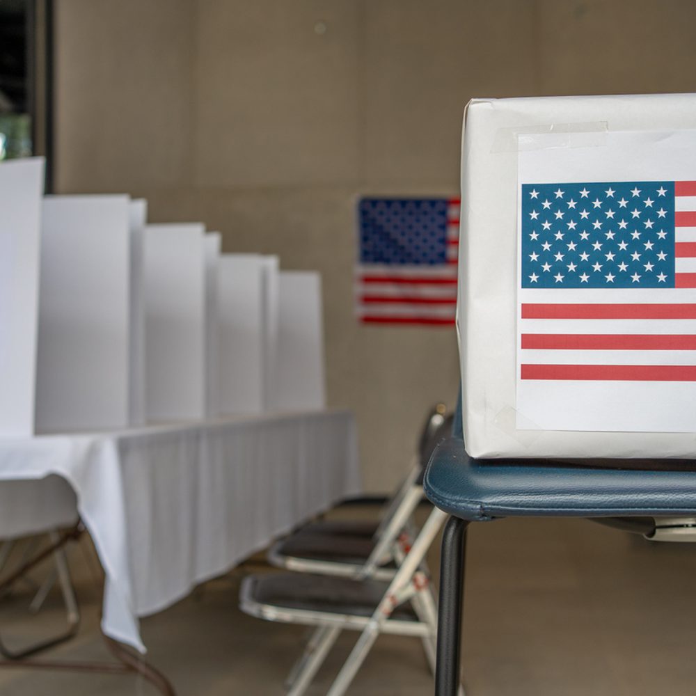 United states of america presidential election polling place, vote center, poll box and voting booth, us flag on the wall stock photo Alabama News